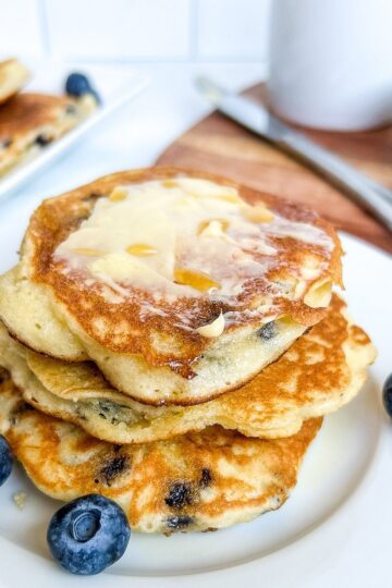 Stack of pancakes with blueberries.