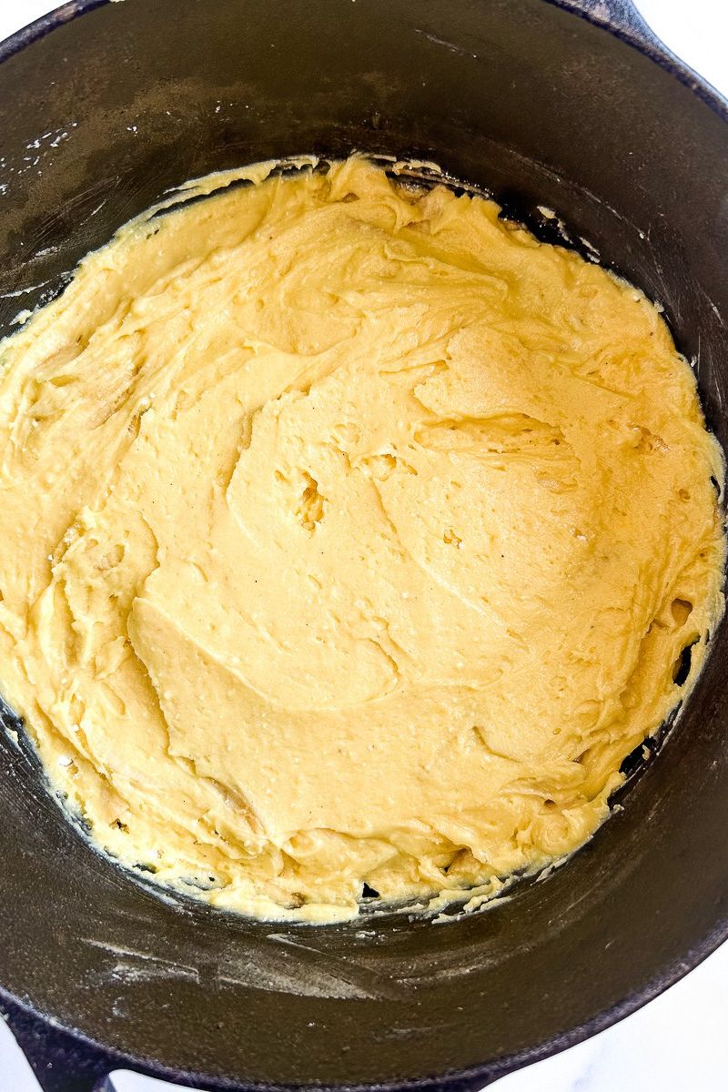 Prepared apple cobbler in a Dutch oven.