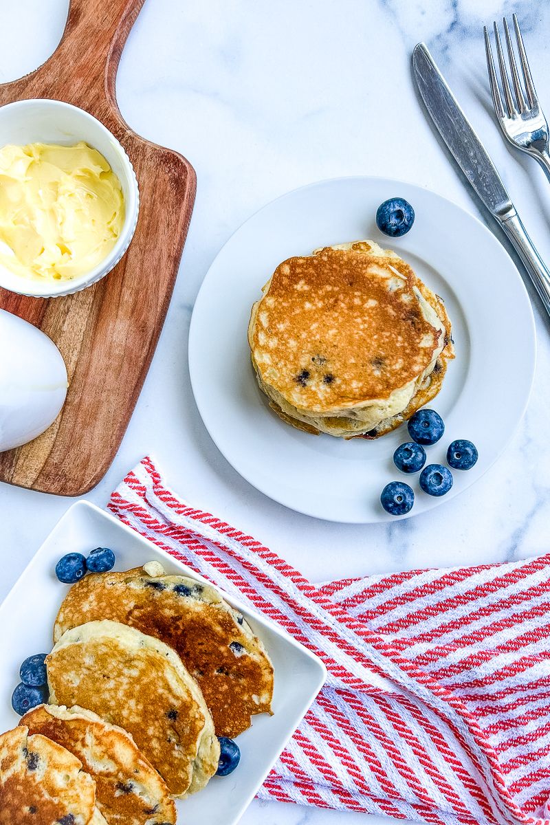A plate and platter of pancakes.