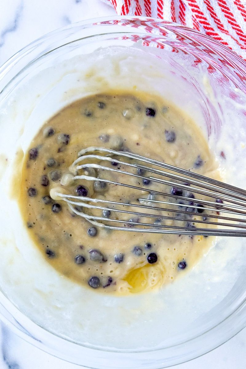 Pancake batter in a mixing bowl with whisk.