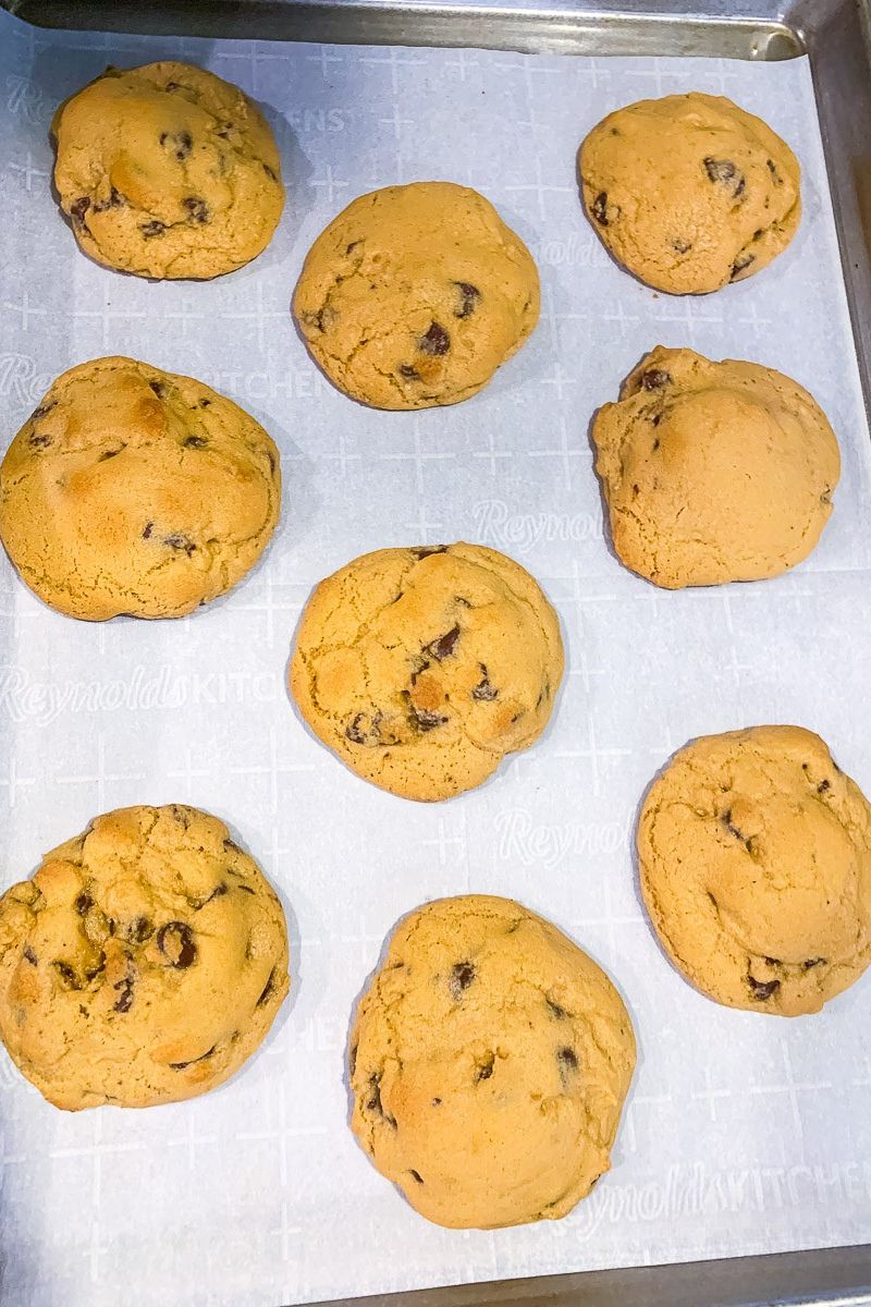 Baked cookies on a baking sheet with parchment paper.