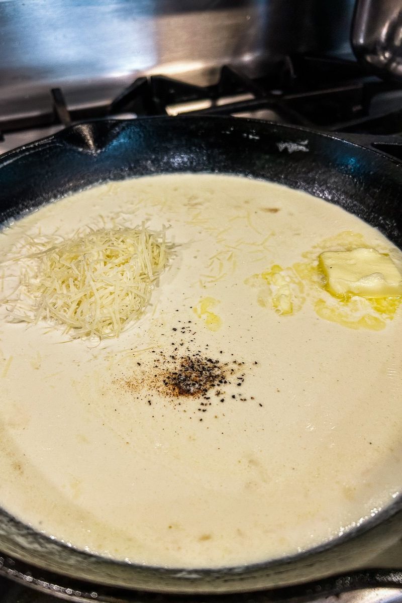 Alfredo sauce in a skillet pan.
