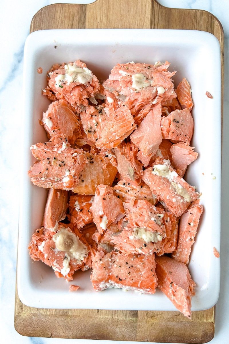 Salmon with seasonings on a platter.