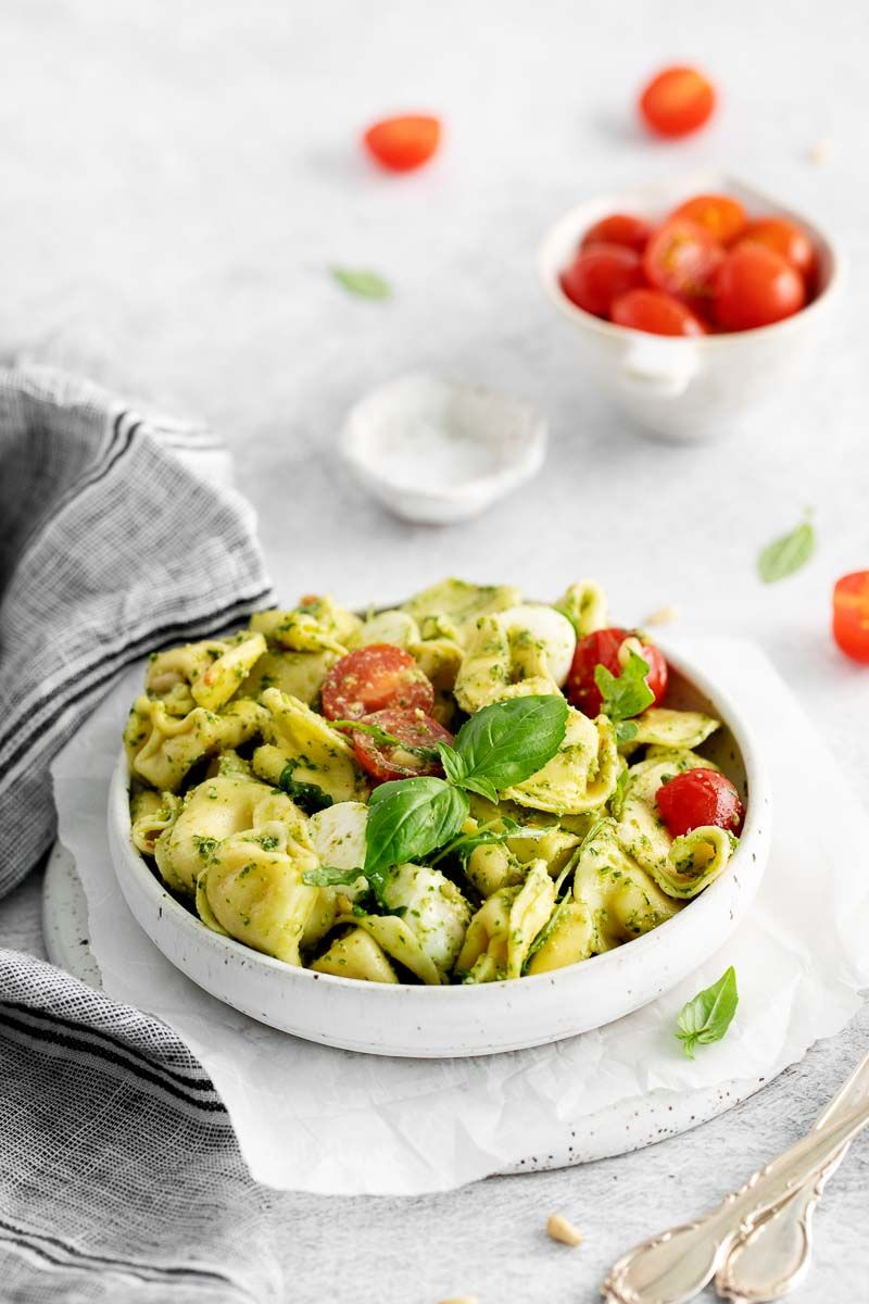 A bowl of pesto with tortellini.