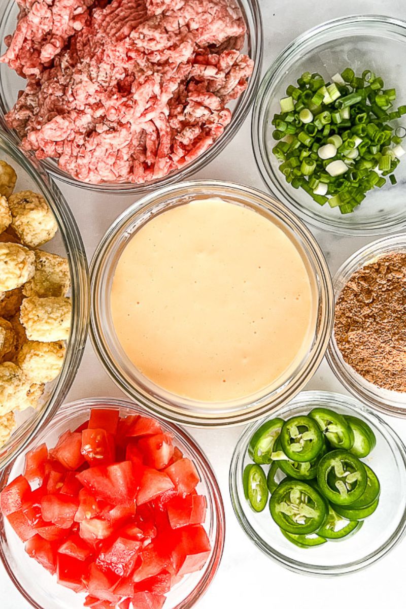 Raw ingredients for totchos in glass bowls.