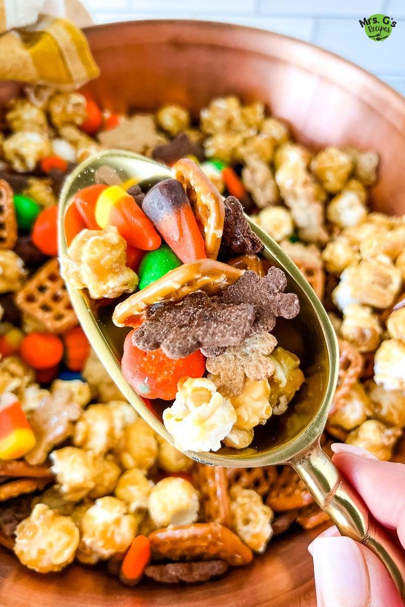 A scoop of Halloween snack mix.