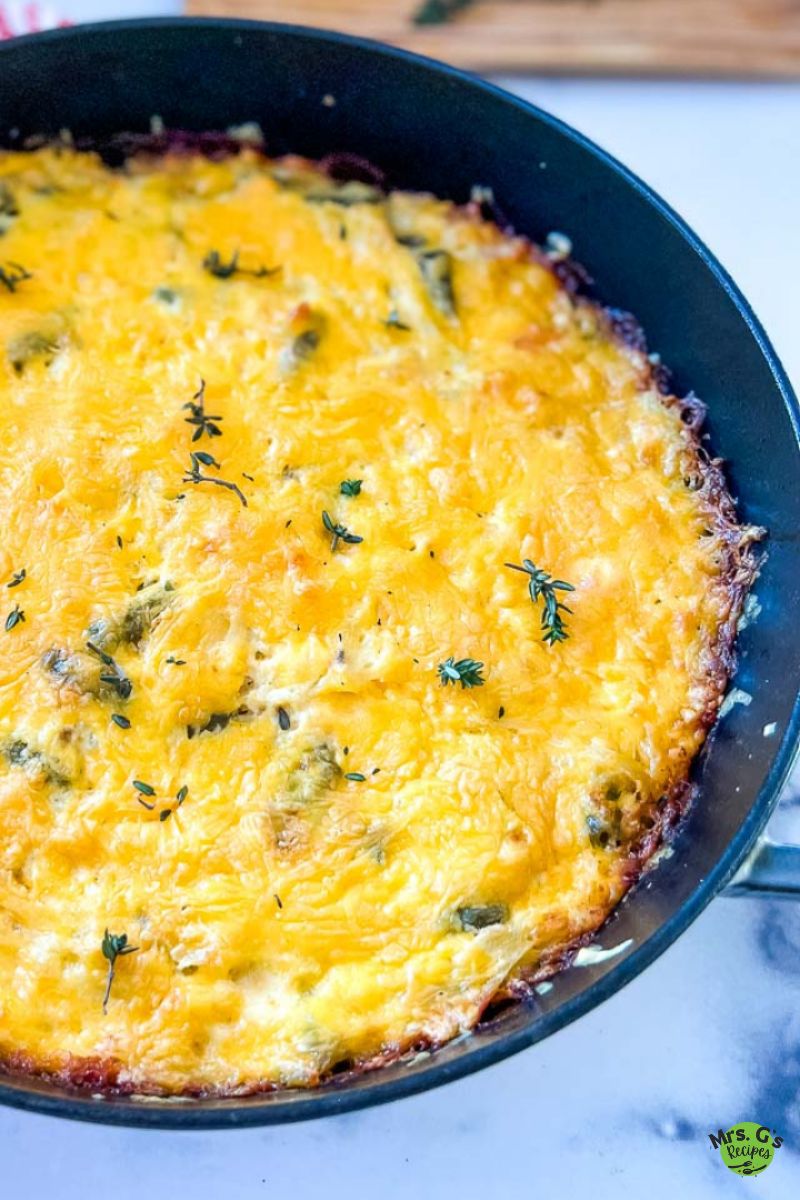 A skillet pan of chicken and hash brown casserole.
