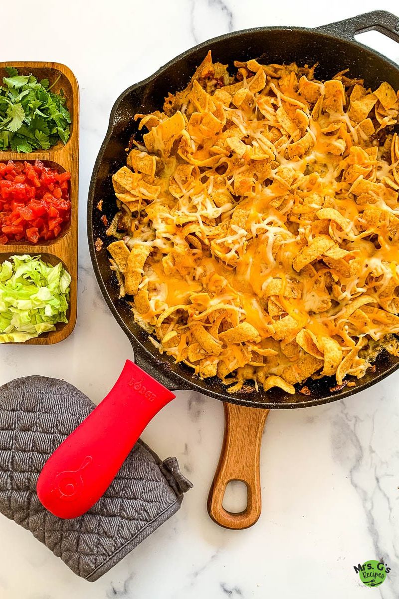A skillet of frito pie casserole.