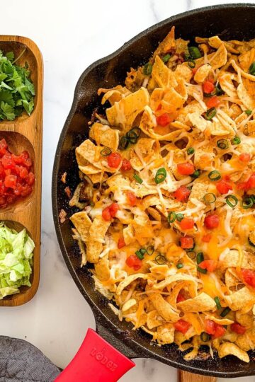A skillet of frito pie casserole.