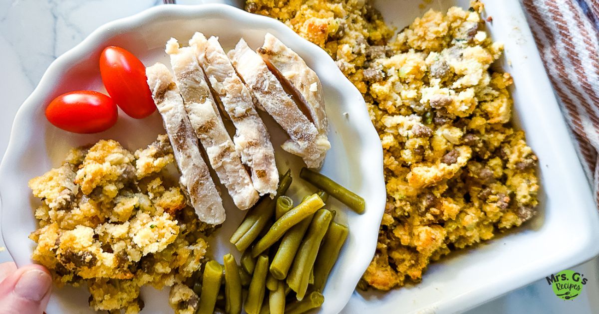 A platter of jiffy cornbread stuffing with a plate of stufiing with meat and vegetables.