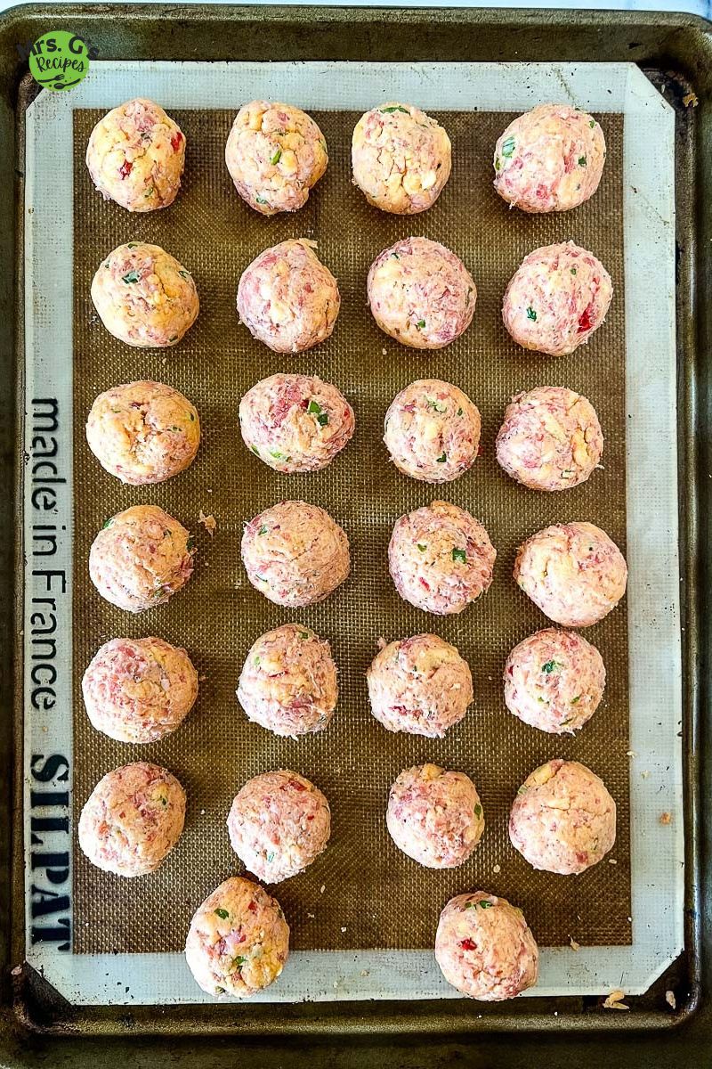 Sausage balls on a baking sheet.
