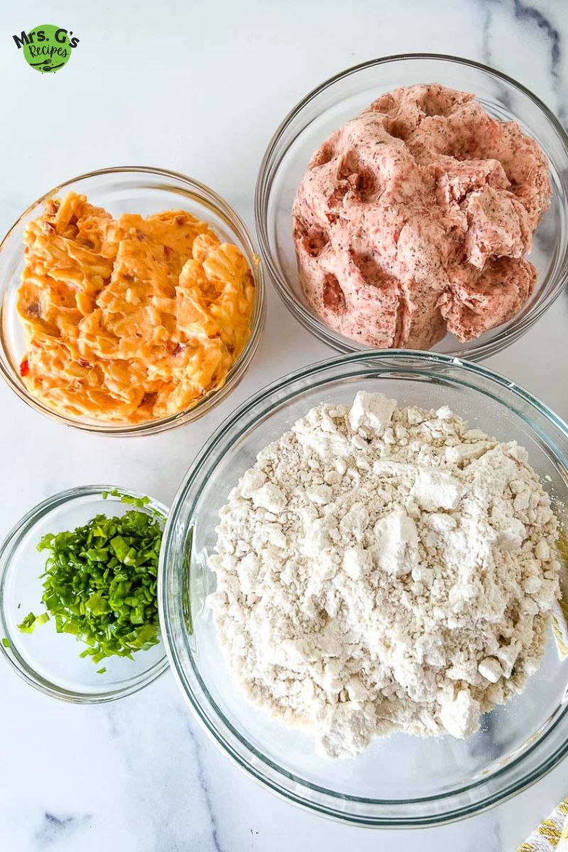 4 bowls of raw ingredients for cheese sausage balls.