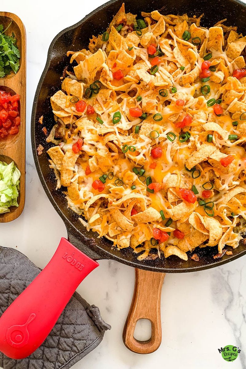 A skillet of frito pie casserole.