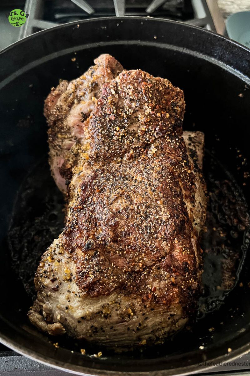 a pot of pork shoulder sprinkled with chili powder and cumin.