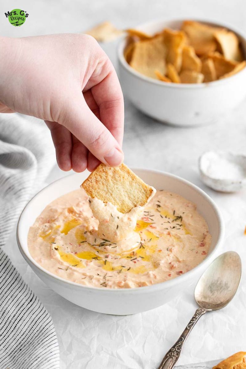 a bowl of roasted red pepper feta dip.