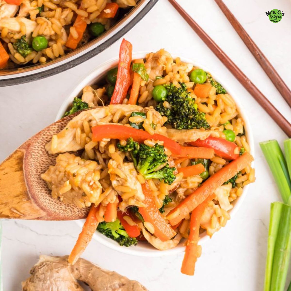 a spoonful of fried rice with veggies and chicken.