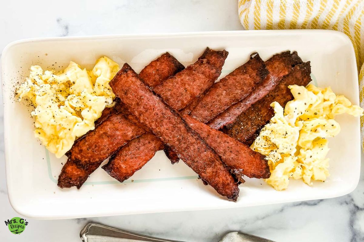 a plate of baked turkey bacon and egg.