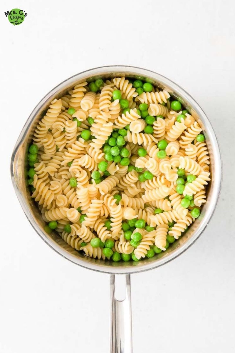 a large pot with pasta and peas.