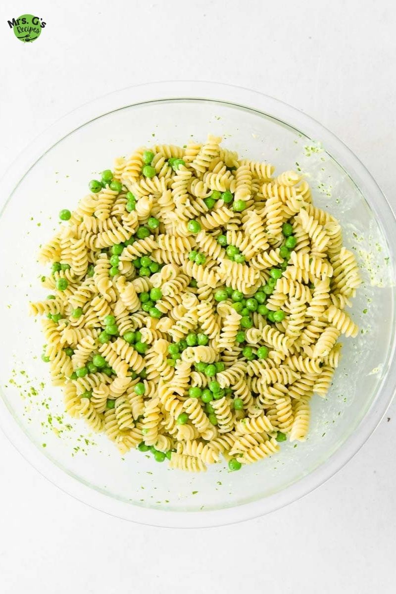 a bowl of pasta and peas with pesto.