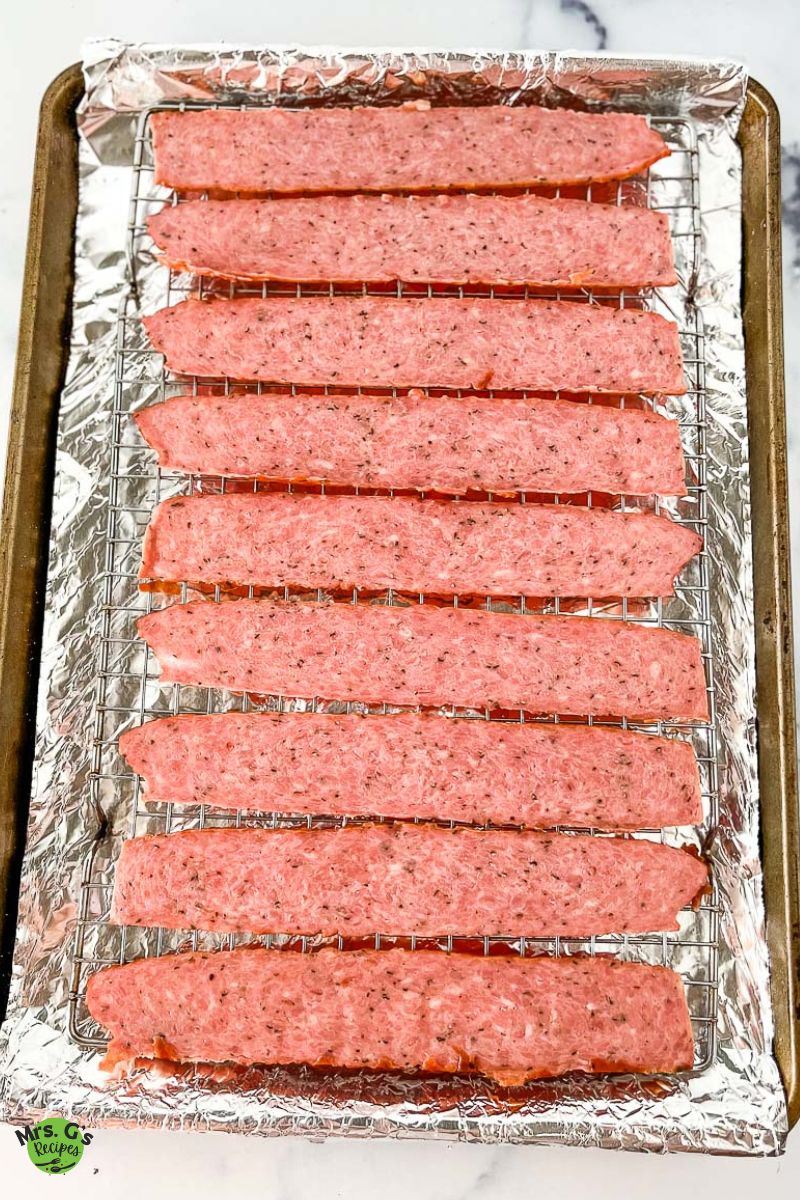 turkey bacon strips in a baking rack.