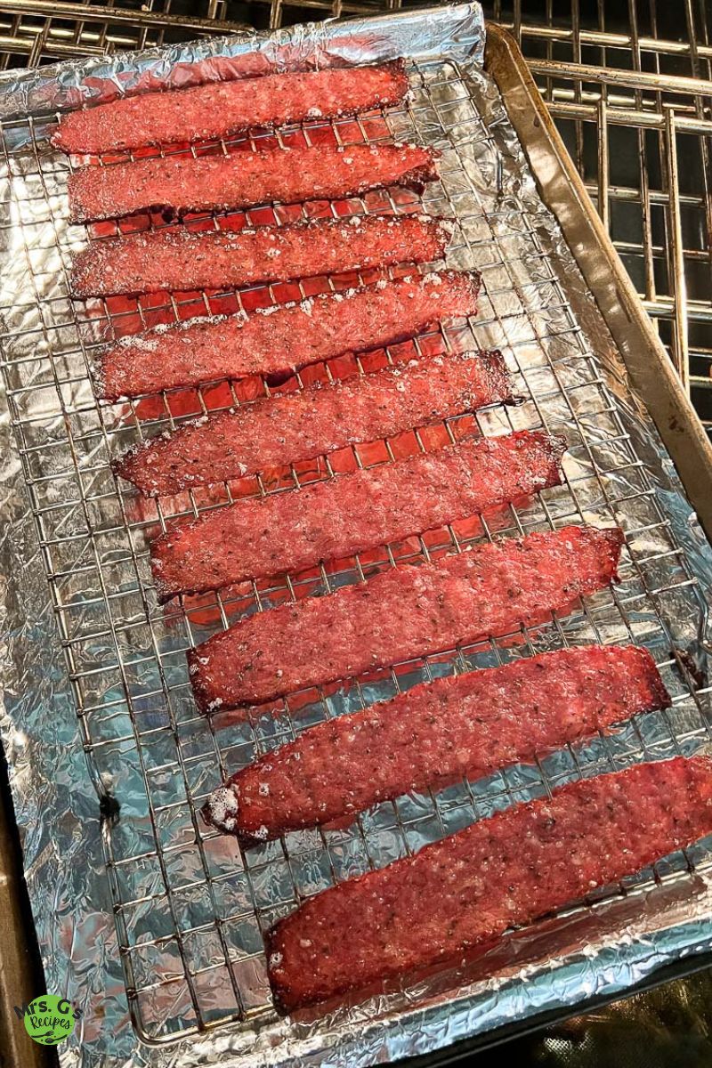 turkey bacon strips in a baking rack.