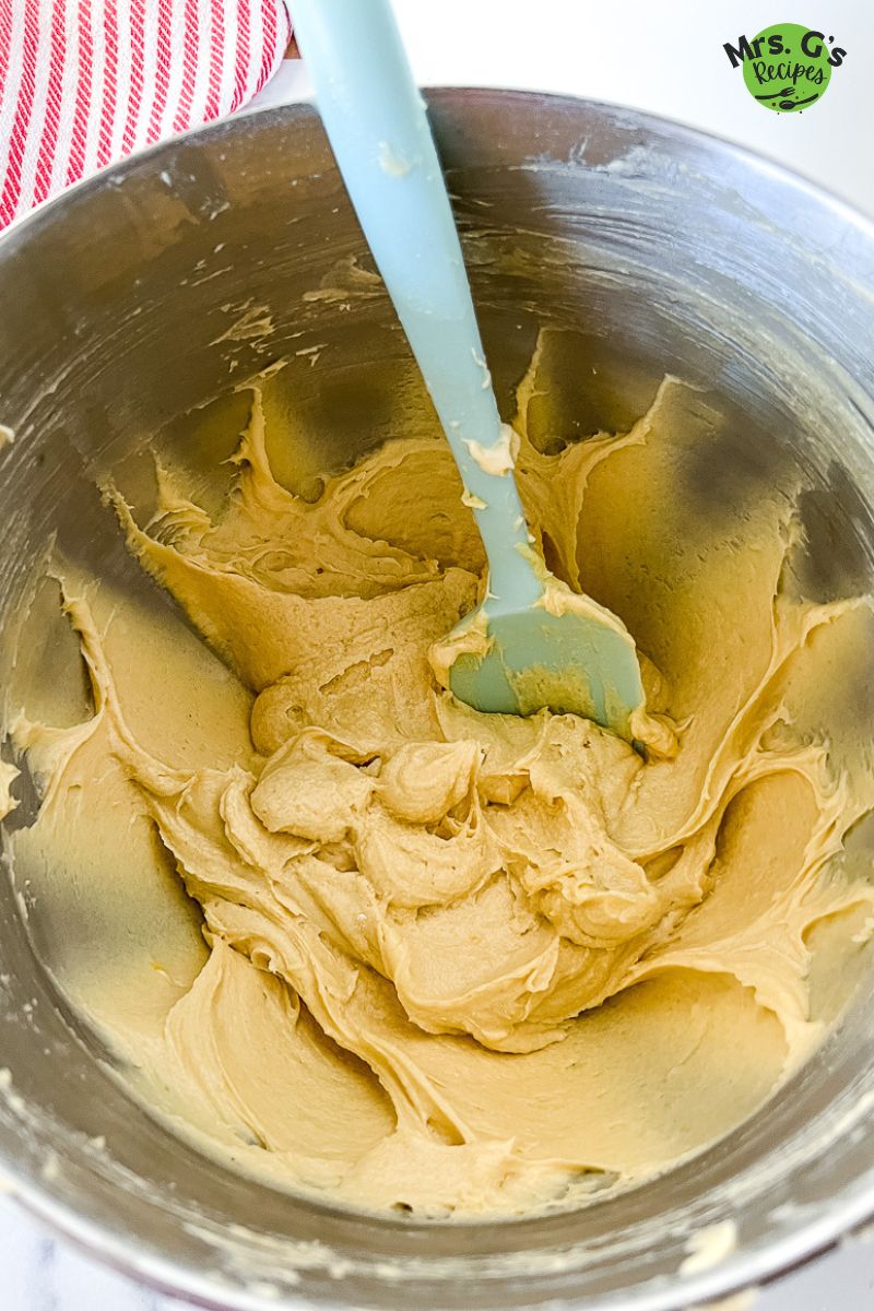 Mixing spatula in a mixing bowl of cake batter.